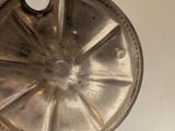 a silver plate with a hole in the middle of it