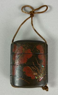 a small black case with red flowers on it