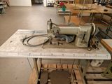 a sewing machine sitting on a table in a factory