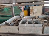 a machine that is making concrete blocks in a factory