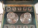 two empty glasses in a green box on a table