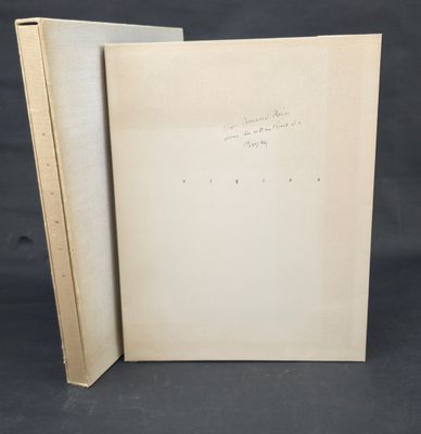 an open book sitting on top of a table next to a black background