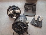 a steering wheel, pedals, and pedal pedals on the floor