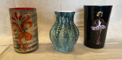 three vases sitting next to each other on a table