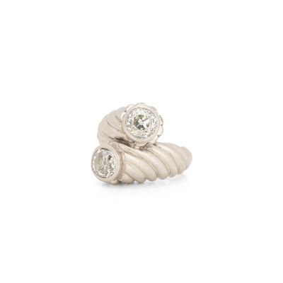 a close up of a ring with two diamonds on it