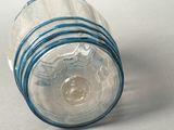 a clear glass jar with a blue band around it