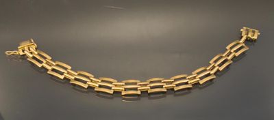a gold necklace on display on a table