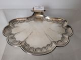 a silver plate with a scallop design on it