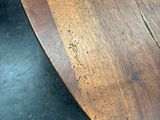 a close up of a wooden table on a black surface