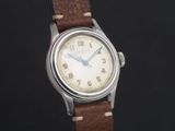 a close up of a wrist watch with a brown leather strap