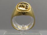 an image of a gold ring with a monogram on it