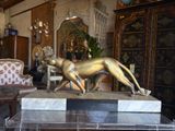 a statue of a dog on a pedestal in a living room