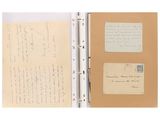an open book with a piece of paper and a pen on top of it