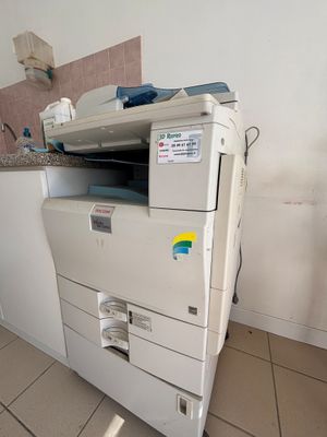 une imprimante blanche posée sur un meuble blanc
