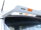 a white truck with an orange light on it ' s roof