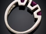 a close up of a ring with a purple stone in the middle