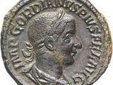 une pièce d'argent sur laquelle figure la tête d'un homme coiffée d'une couronne