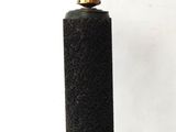 a black and gold lamp with a gold cup on top of it