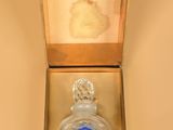 an image of a bottle of perfume in a box on a table