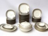 a lot of plates and bowls on the table