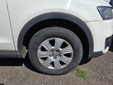 a white car that is parked on the side of the road