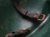 a green bowl that has a metal handle in it