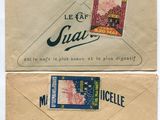 two envelopes with stamps on them sitting on top of each other