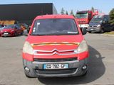 a red van that is parked in a parking lot