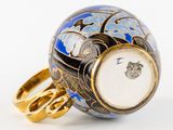 a blue and white vase with a gold ring on it
