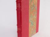 a red book that is sitting on a white surface