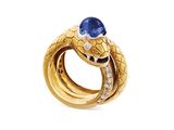 an image of a gold snake ring with a blue sapphire stone
