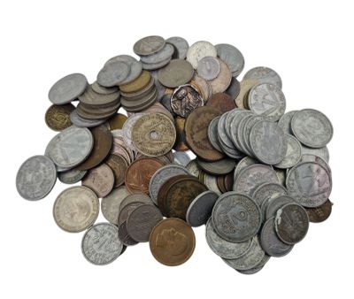 a pile of old coins on a white surface