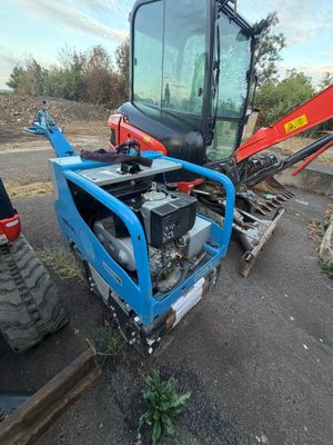 a small tractor that is parked on the side of the road