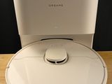 an image of a white robot sitting on top of a wooden table
