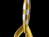 a gold and white rocket shaped christmas ornament hanging from a gold ribbon