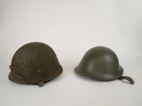 two helmets are sitting side by side on a white surface