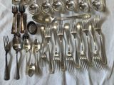 a lot of silver spoons and forks on a table