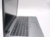 two laptops that are open on a white surface