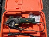 a tool in a case with a cord and a tool in it