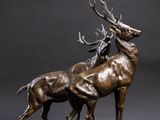 bronze sculpture of two stagss standing on a rock