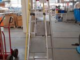 a picture of a large warehouse with a ladder and a hand truck
