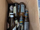 many bottles of beer in a cardboard box on the floor