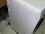 a washing machine sitting on the floor in a room