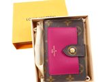 louis vuitt wallet in a box with a pink card holder