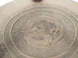 a silver plate with a picture of a man and a woman on it
