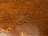 a close up of a piece of wood with a bird on it