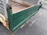 a green truck that is parked in a parking lot