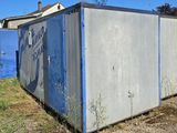 a blue and white container sitting in the middle of a yard