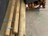 a pile of wood sitting on the ground next to a pile of boxes