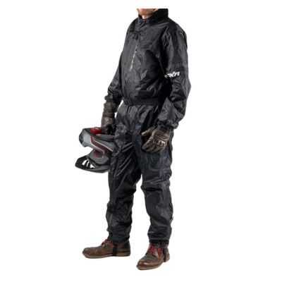 the man in the rain suit is holding a helmet and helmet